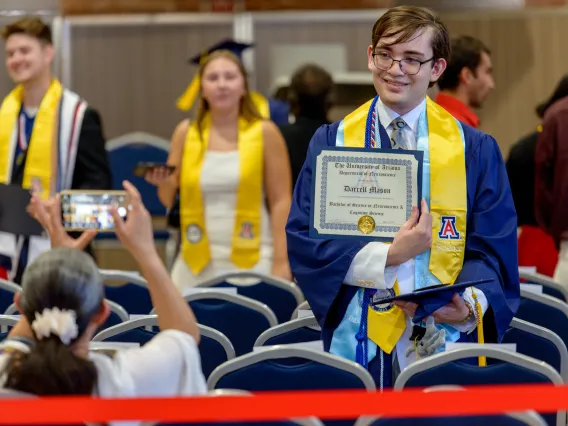 Darrell Mason showing off recently received diploma.