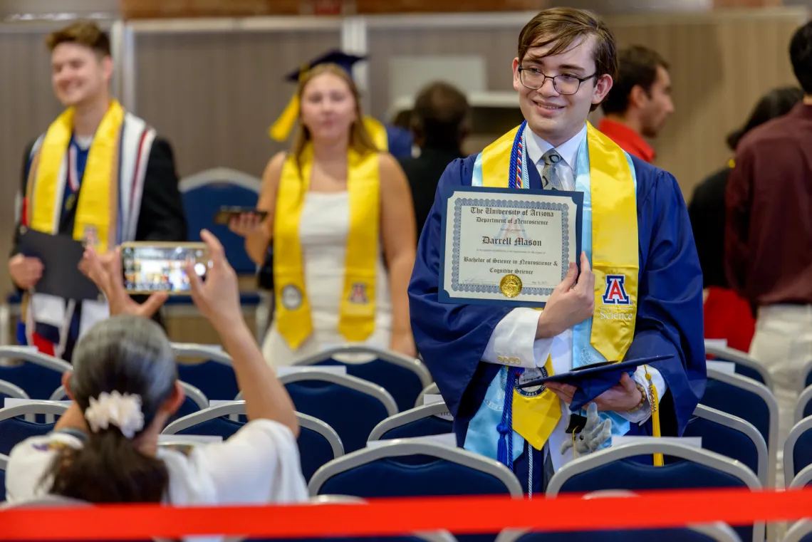Darrell Mason showing off recently received diploma.